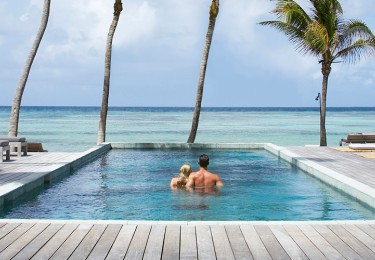 Couple Relaxing On Vacation At Luxury Resort In The Caribbean