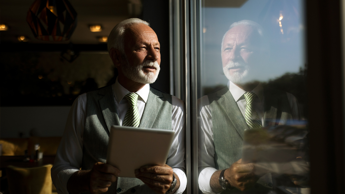man looking out of window