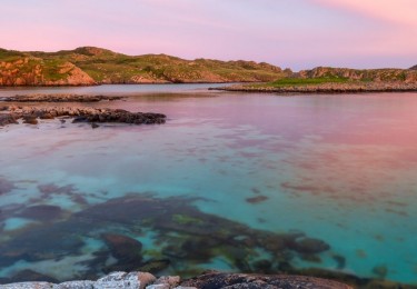 Ross of Mull sandy beach at sunset with clouds and crystal water