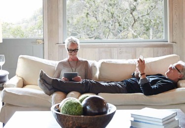 Mature Couple With Grey Hair Looking At Digital Tablet And Phone Mature Couple With Grey Hair Looking At Digital Tablet And Phone