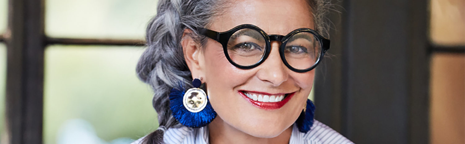 Portrait Of Beautiful And Stylish Mature Woman  With Grey Hair Sitting On Front Porch Of Her Home