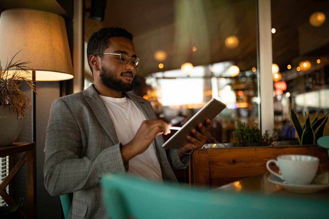 Designer is drawing on a tablet at cafÃ©