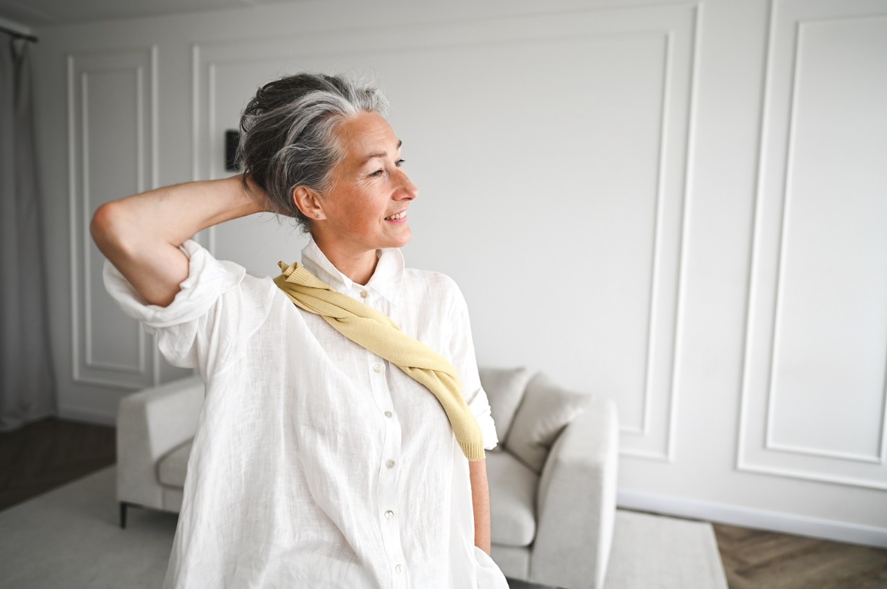Side view portrait of cheerful woman with gray hair.